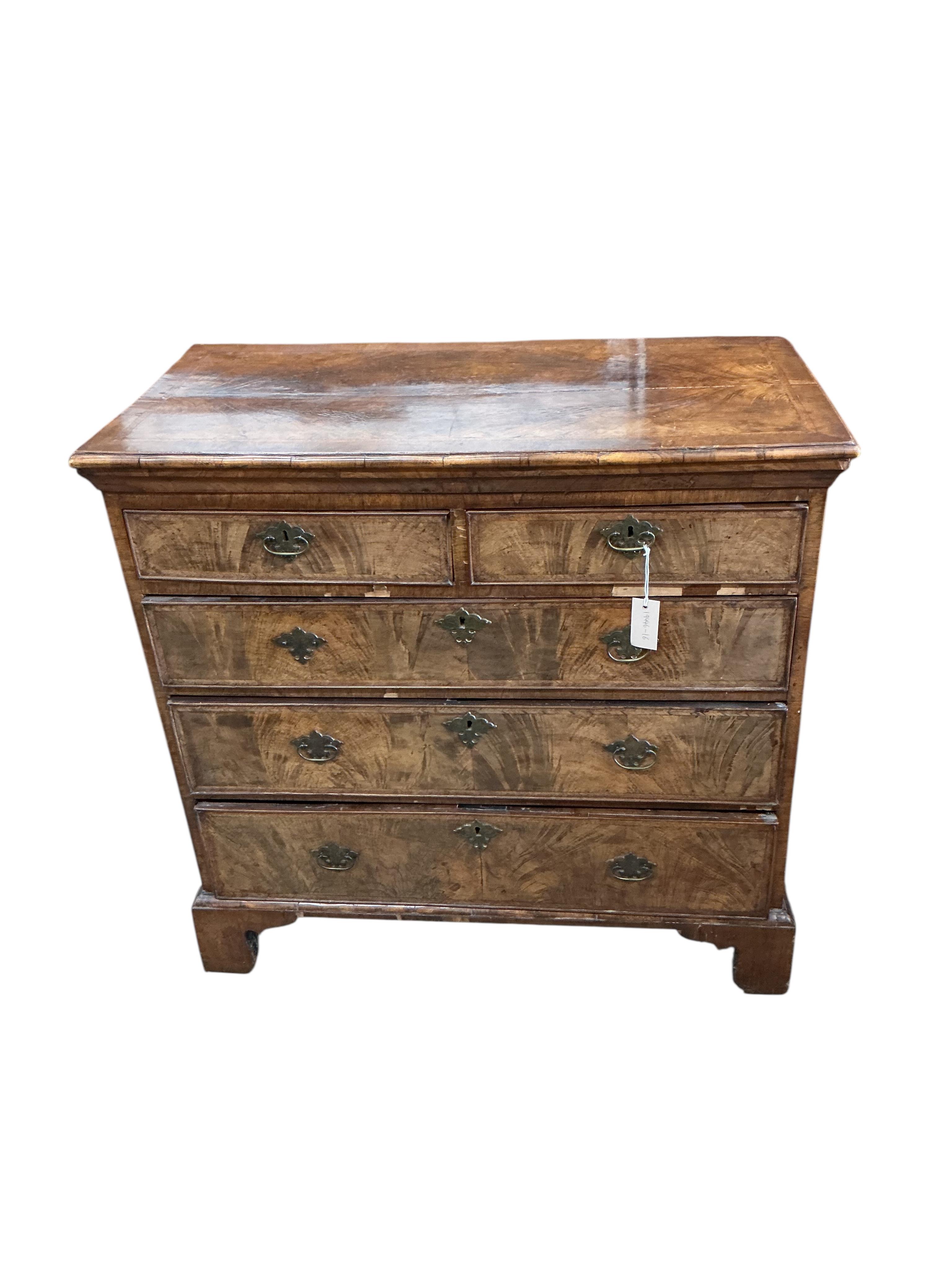 A George II feather banded walnut chest of drawers, width 94cm, depth 48cm, height 92cm